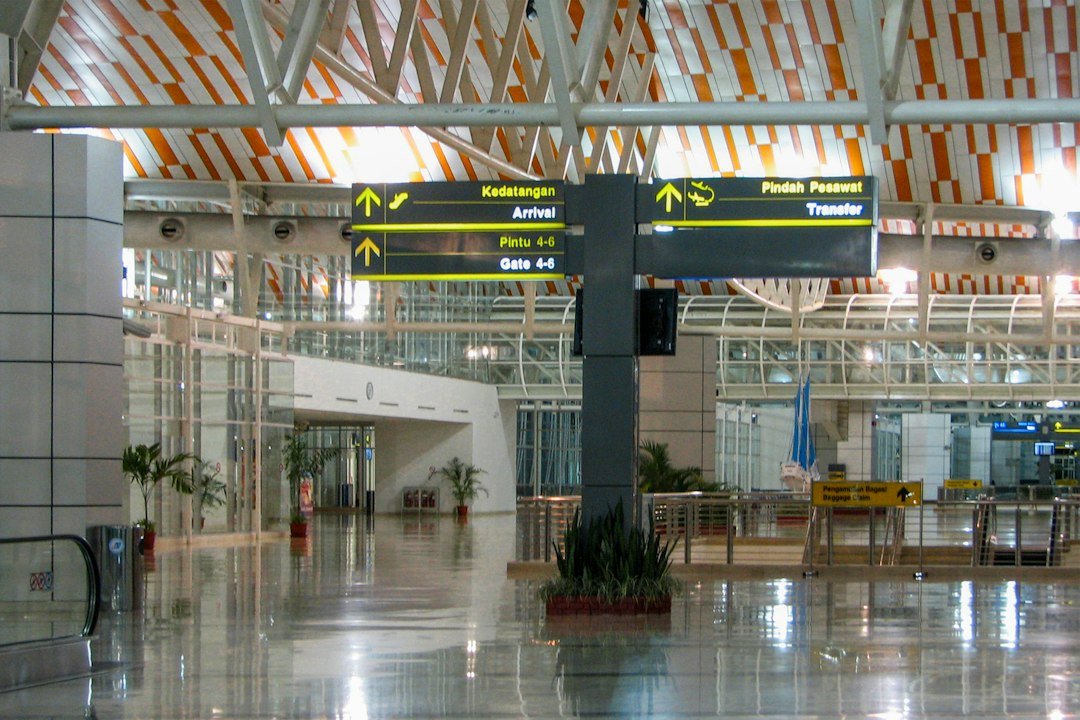 Inside an airport terminal, with signage