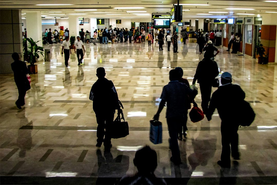 People are walking through a busy airport terminal